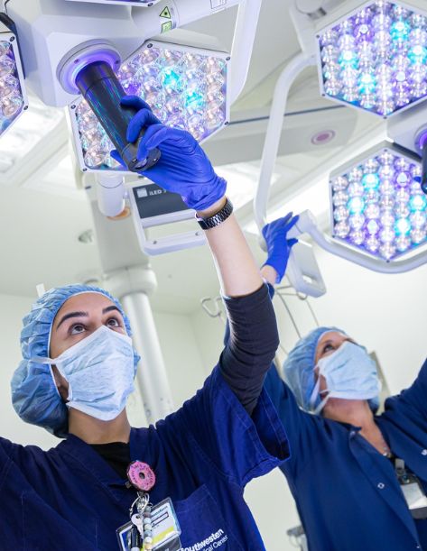 A nurse holding and reading the label on some medical supplies