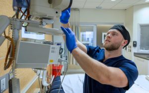 Male nurse checking stats.